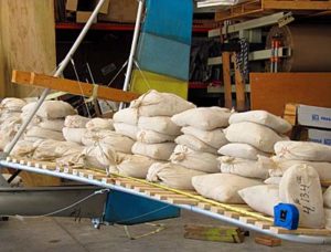 Images shows the Lockwood Aircraft Drifter in load testing. Note the tape measure used to position loads accurately. Wood is used to spread the load across the tubing structure after the Dacron covering has been removed.