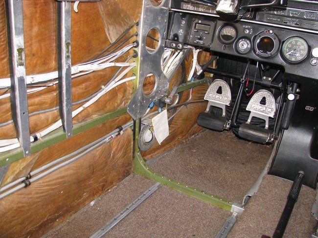 Left side of airplane interior with covering removed for annual inspection