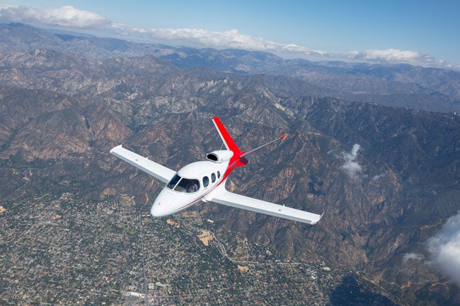 Cirrus SF50 Vision Jet over mountains