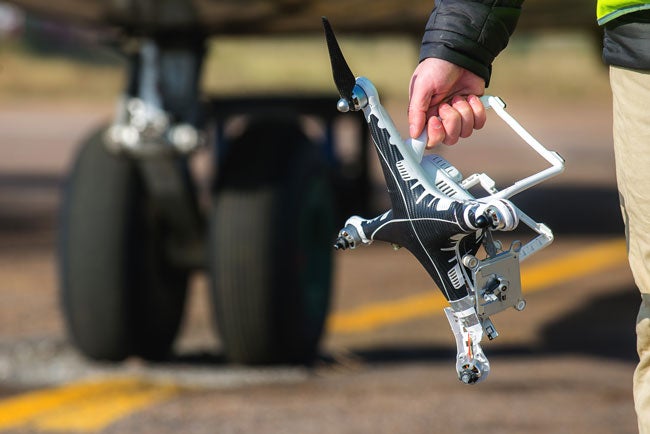 man carrying drone