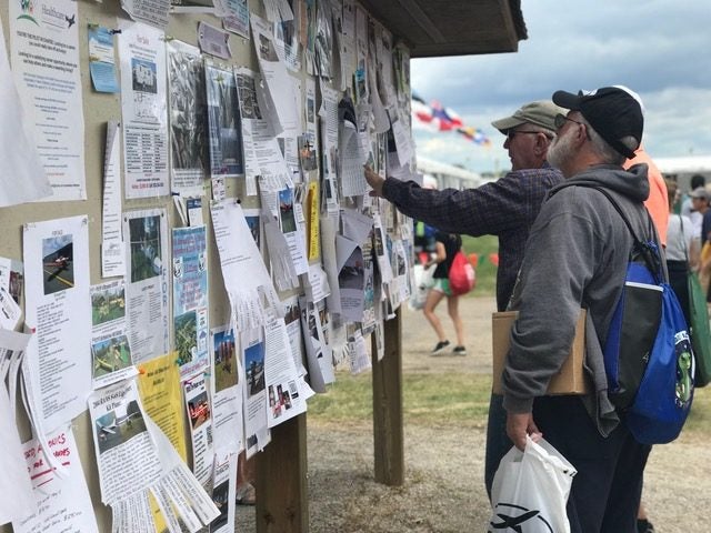Pilots looking at the bulletin board.