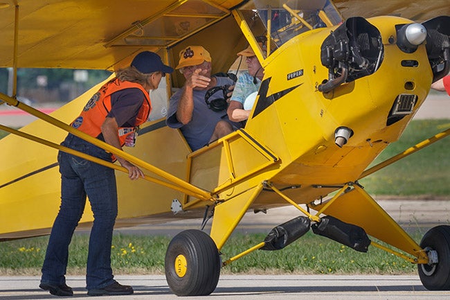 A Super Cub getting parking directions. 