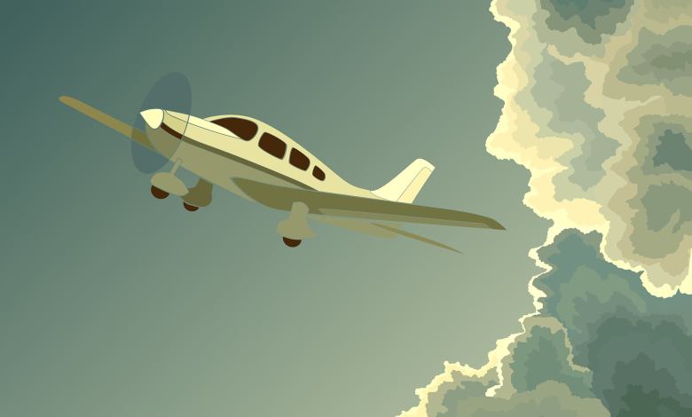 Plane flying out of clouds