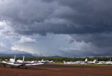 Small planes with storm clouds overhead
