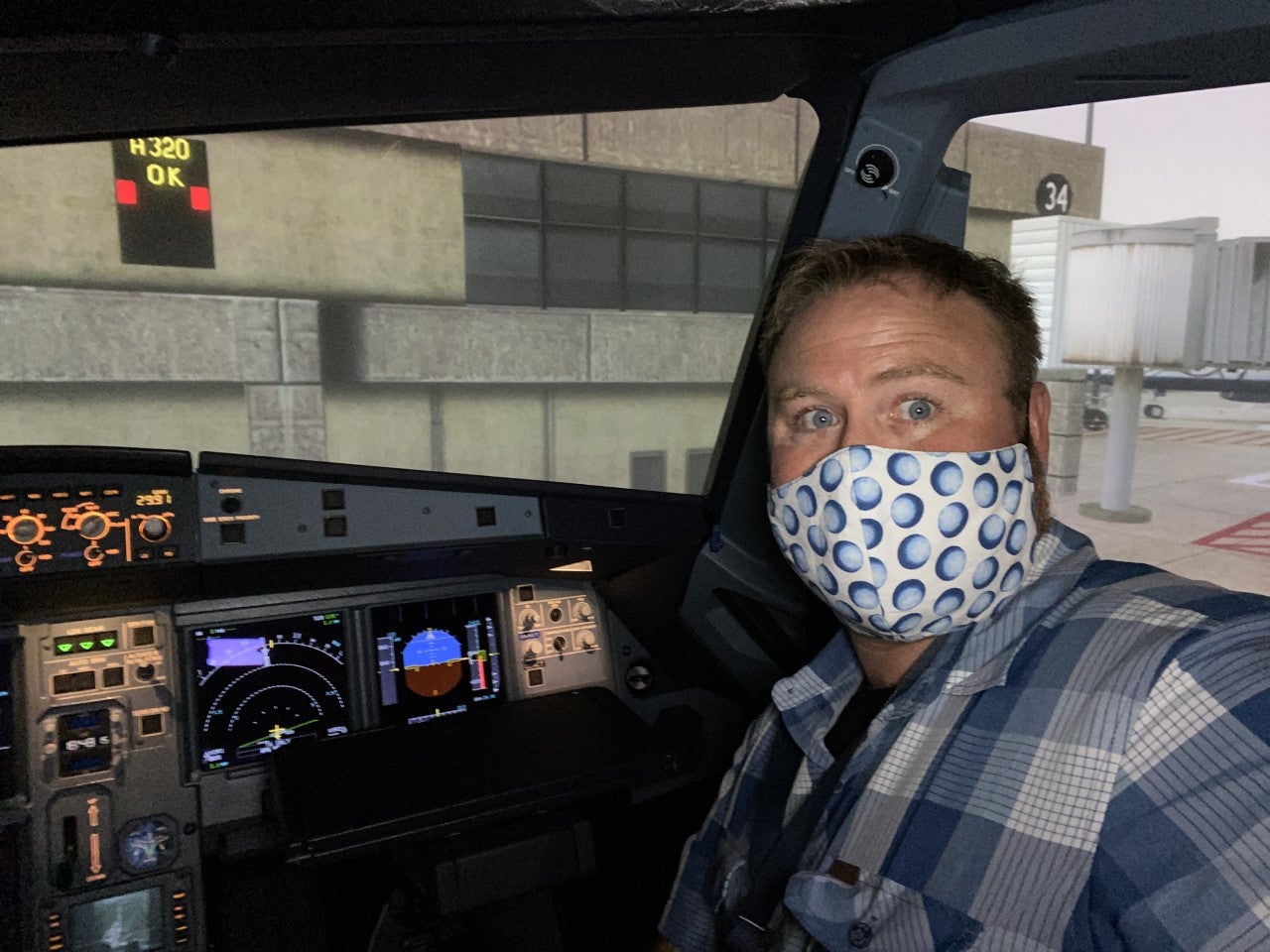 The author, the pandemic beard ’hidden under the mask,’ in the Airbus simulator getting ready to knock the rust off. Photo by Jeremy King
