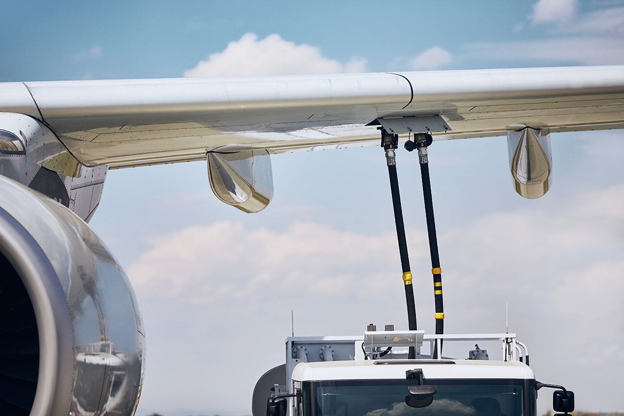 A fuel truck servicing an airplane.