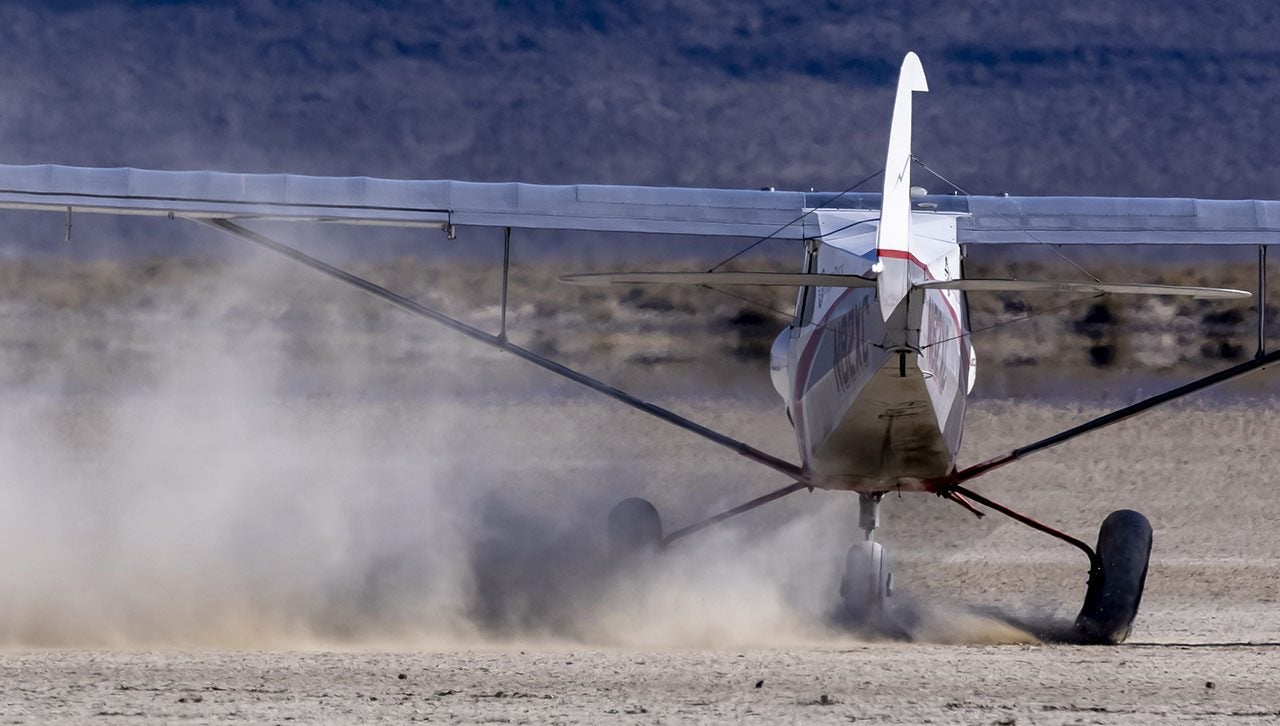 A CubCrafters NX Cub is at home on a dry lake bed. Photo by Jim Raeder.