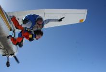 2 people jumping out of a Cessna 182