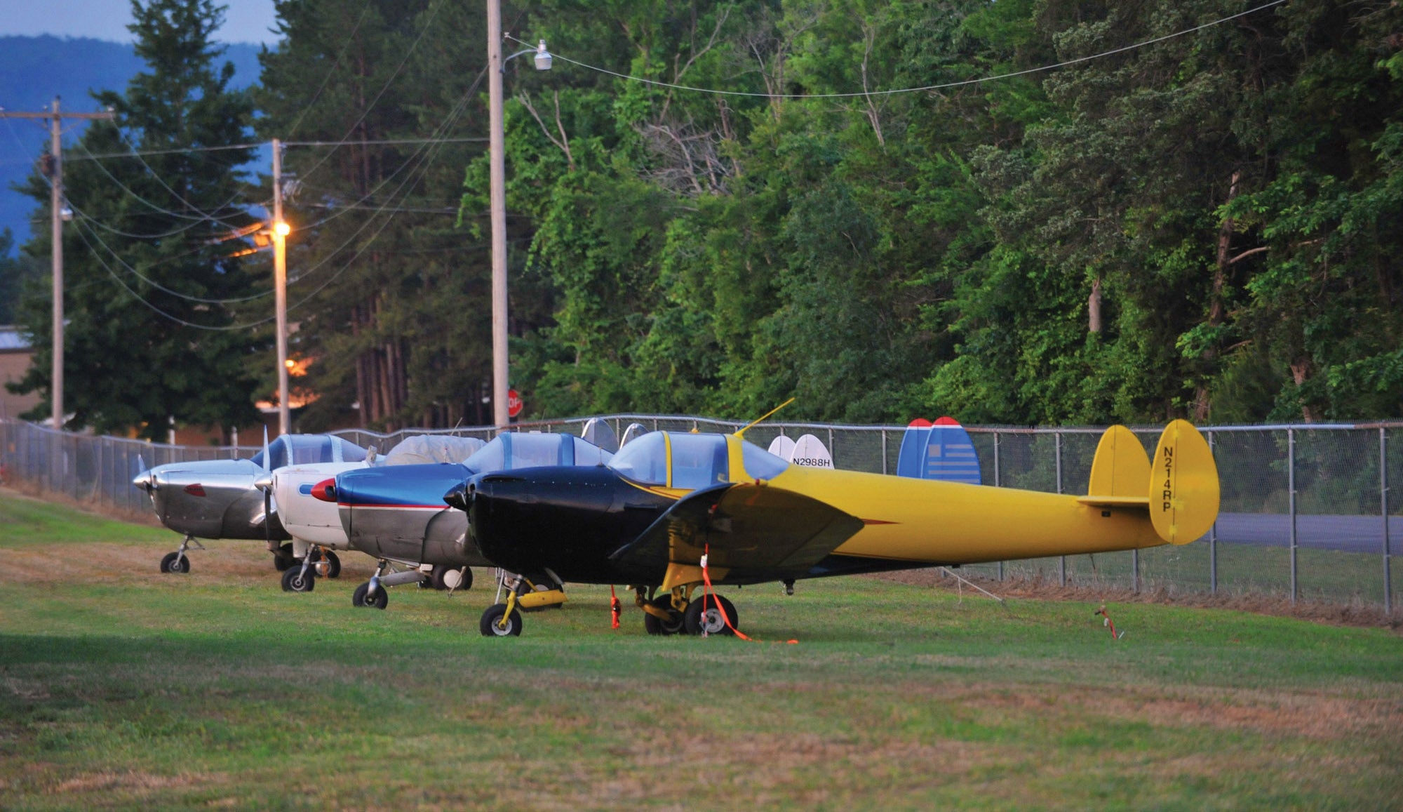 Ercoupes tied down on a grassy ramp