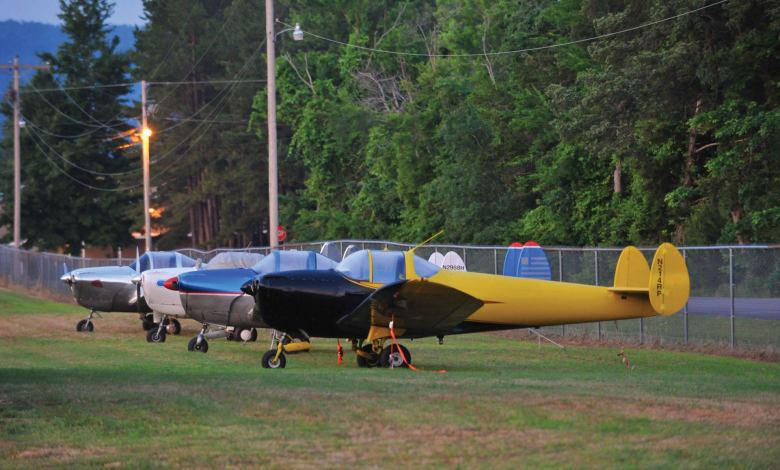 Ercoupes tied down on a grassy ramp