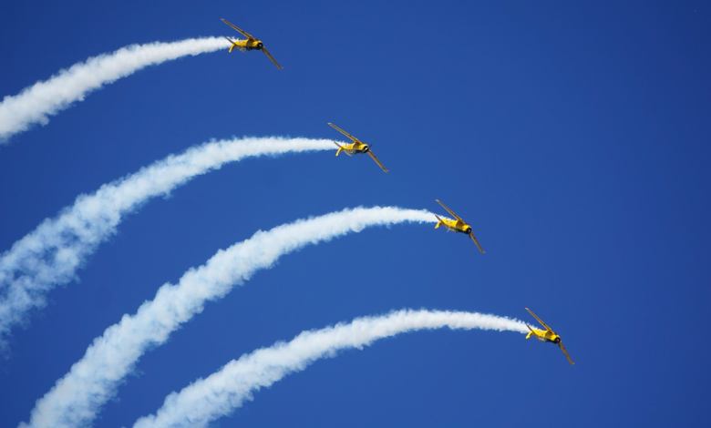 North American T-6 Texans perform at EAA AirVenture Oshkosh. Photo by Cayla McLeod.