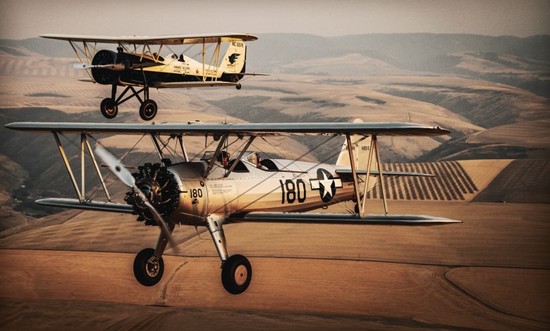 Hangar 180’s Boeing PT-13 Stearman and Stearman 4E Junior Speedmail fly in formation over western Idaho. [Credit: Cayla McLeod]