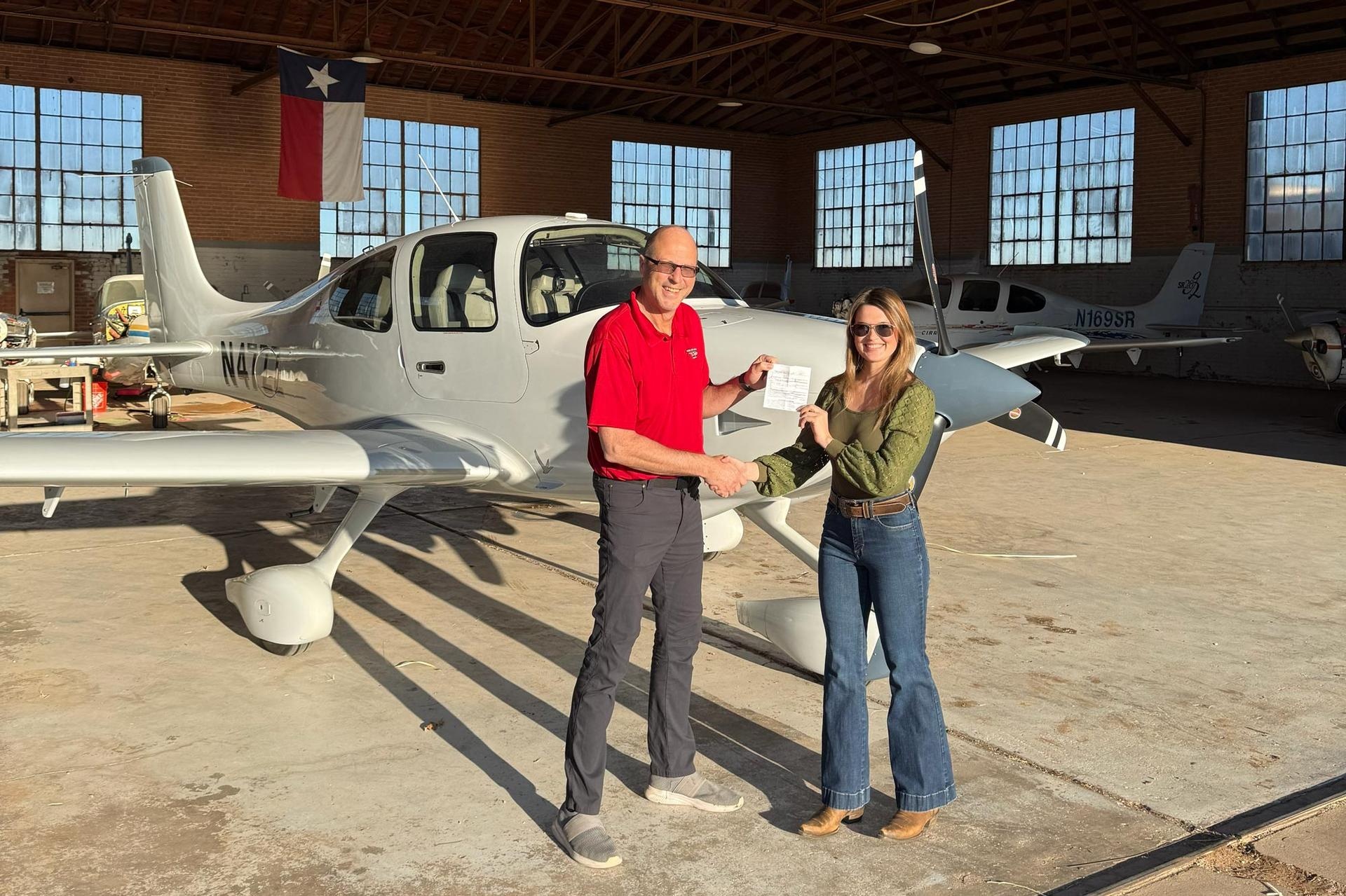 DPE Will Strieder and the author pose after her check ride at Lubbock Preson Smith International Airport (KLBB) in Texas. [Credit: Cayla McLeod]