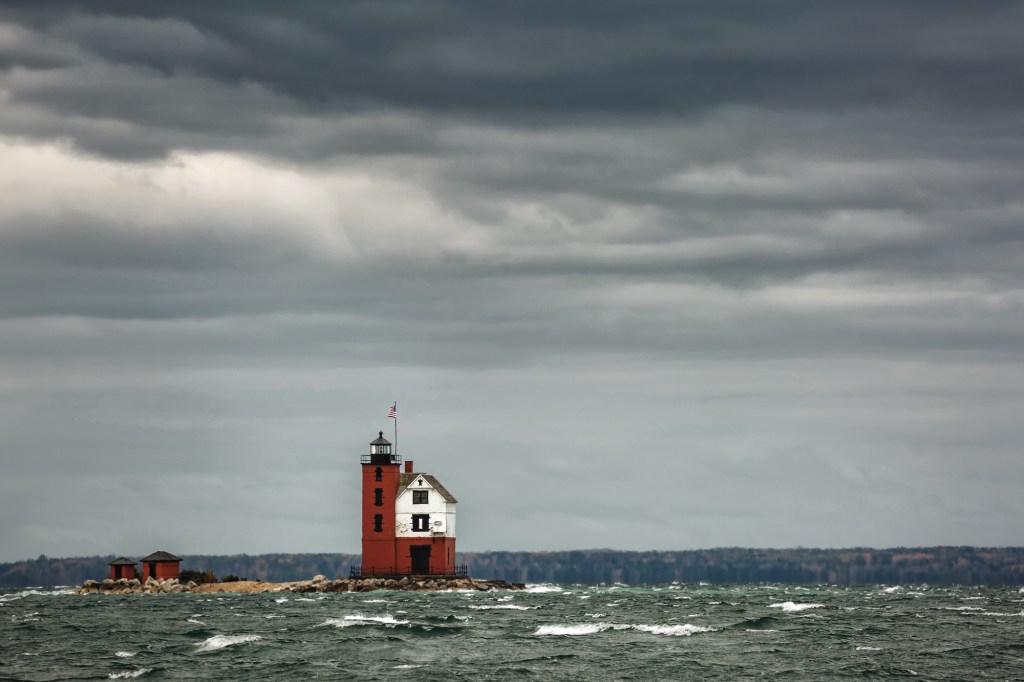 The Round Island Lighthouse, built in 1895, is an iconic brick structure in Mackinac. [Credit: AdobeStock]