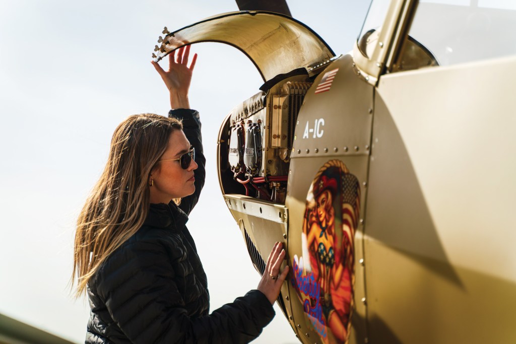 
Cayla McLeod looks over the airplane during a preflight inspection on the Capital Flight ramp in Middleton, Wisconsin. [Credit: Jim Stevenson]