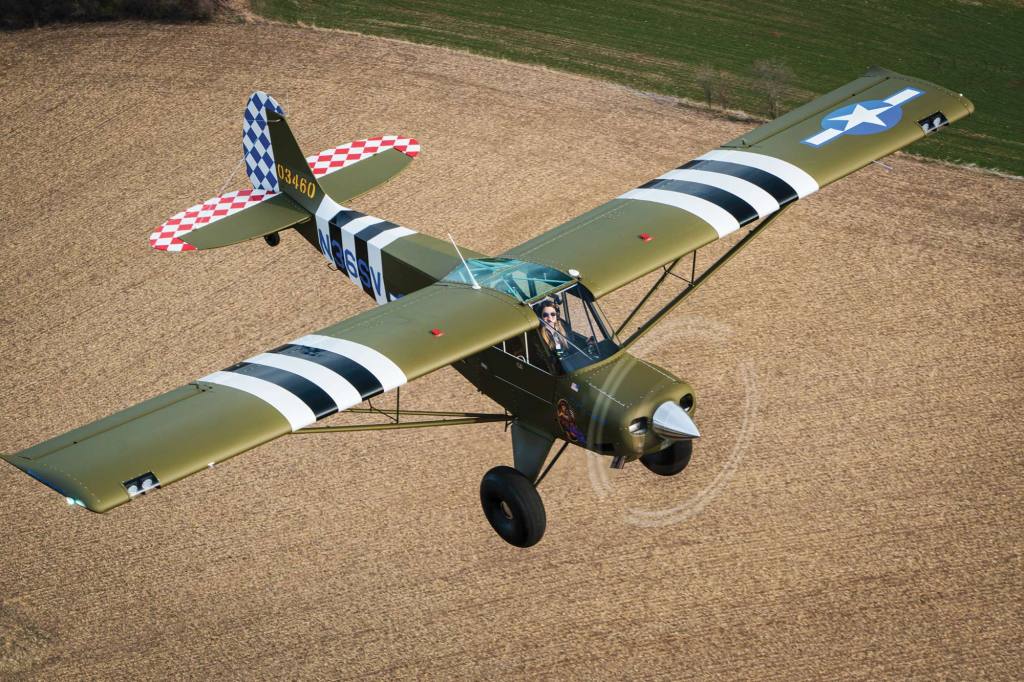 The 200-hp Aviat Husky Liberty Belle flies over the Wisconsin farm fields on the way to a grass strip. [Credit: Jim Stevenson]