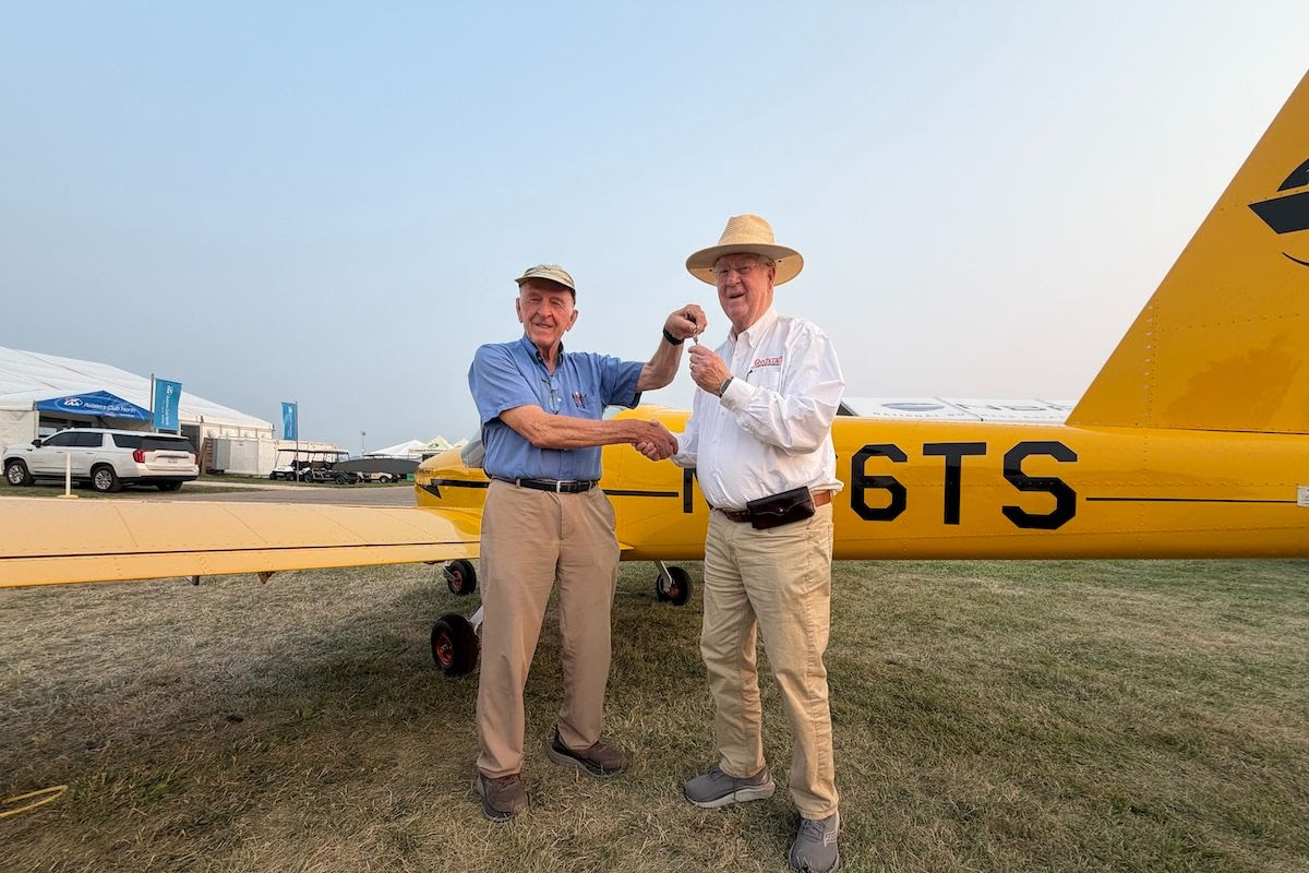 Van's Aircraft founder Richard VanGrunsven (left) hands over the keys to the first MOSAIC aircraft ever delivered to Tom Snow, who chose the Cub Yellow scheme as a tribute to the iconic trainer. [Credit: Van's Aircraft]