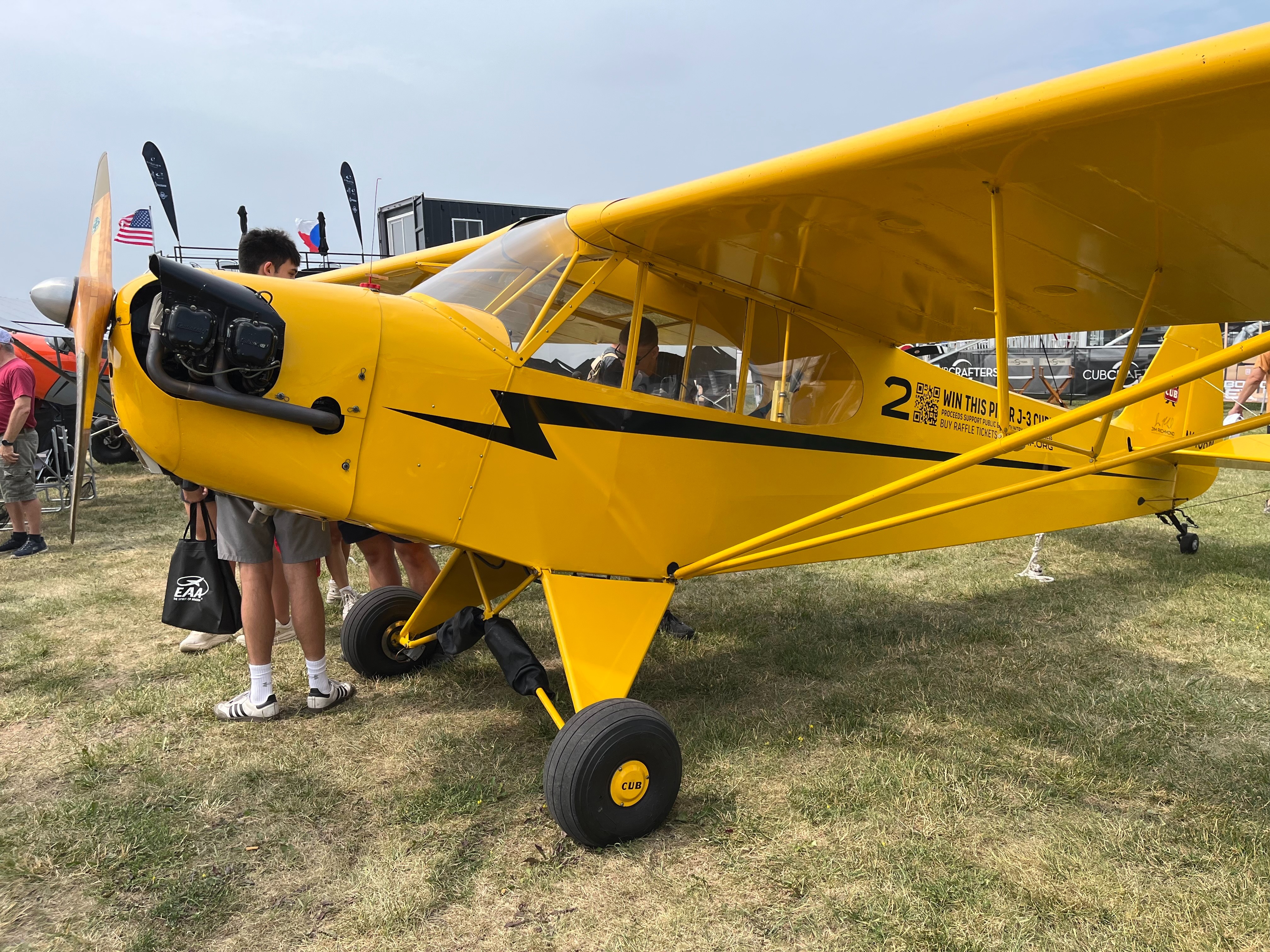 One of three J-3 Cubs being raffled off by the Jim Richmond Backcountry Aviation Foundation on display at Oshkosh. [Credit: Meg Godlewski]