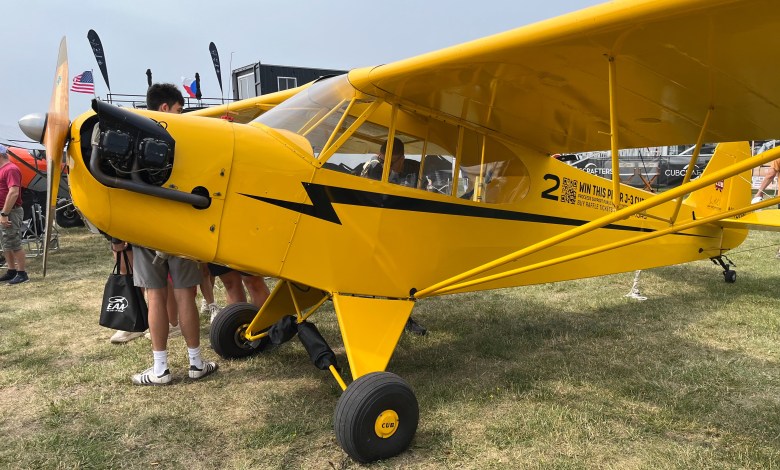 One of three J-3 Cubs being raffled off by the Jim Richmond Backcountry Aviation Foundation on display at Oshkosh. [Credit: Meg Godlewski]