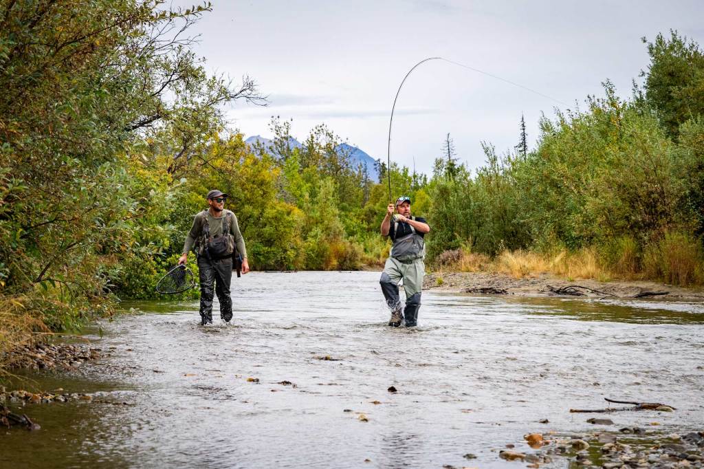 Cast for trout in pristine waters before relaxing in the rustic, warm comfort of Lake Clark Lodge. [Credit: Lake Clark Lodge]