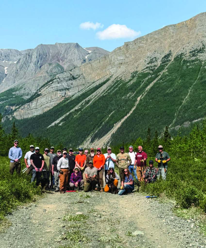 Through collaborative efforts and hard labor, pilot volunteers and land management crews work together at remote sites like Glacier Creek to maintain essential aviation infrastructure. [Credit: Stef Goza]