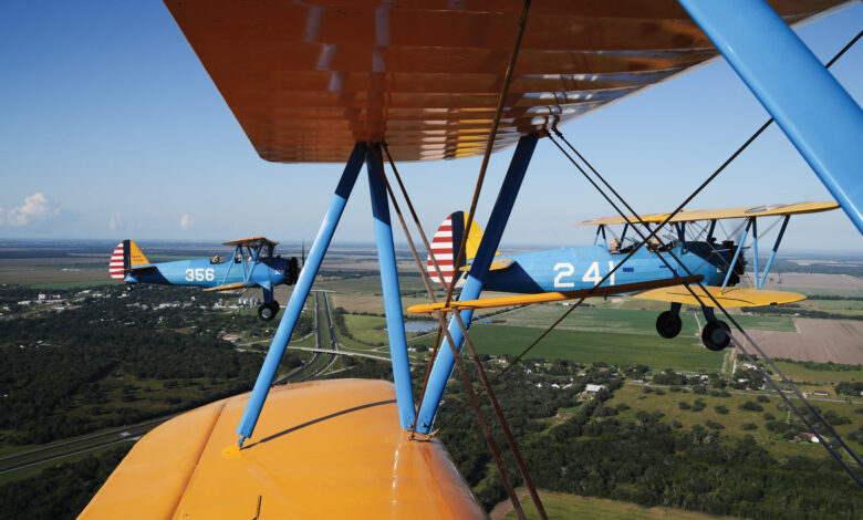 A formation of Boeing PT-17 Stearmans flies high over Louise, Texas, at the annual Under the Wire Fly-In. [Credit: Cayla McLeod]